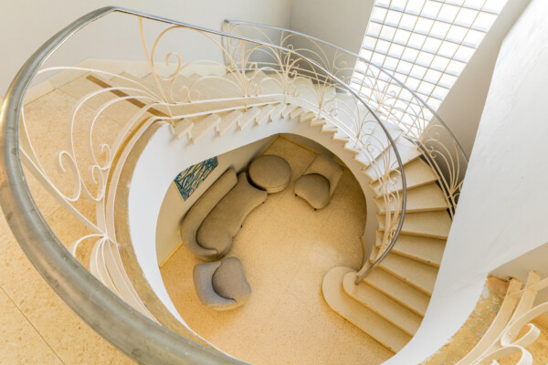 Entree – Elegant entrance with grand stairway and vintage furniture Miramar Residence – Entree with grand round stairway