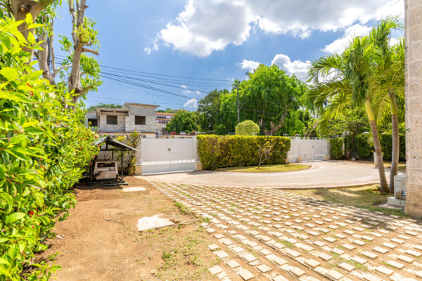Front garden – Elegant gates, entryway and backup generator Miramar Residence – Front garden gates and entryway